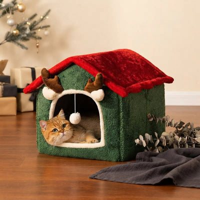 A plush Christmas-themed cat nest sitting on a warm cream surface with soft ambient lighting and festive seasonal decor.